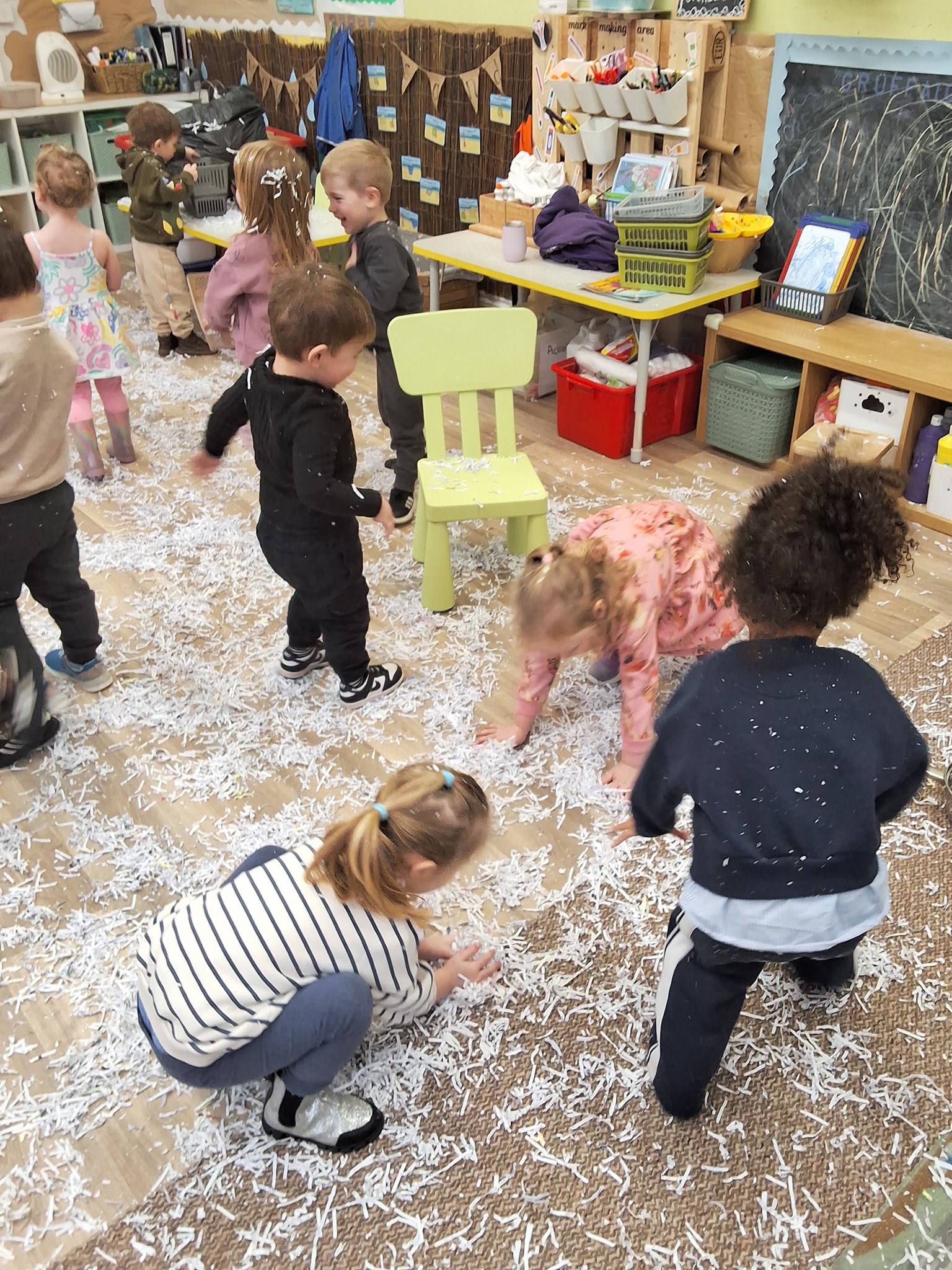 Happy children reading and playing with wooden toys at Bookworms Daycare